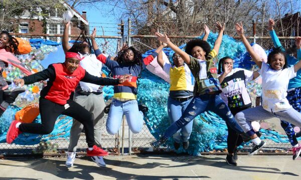 group of students jump up into air