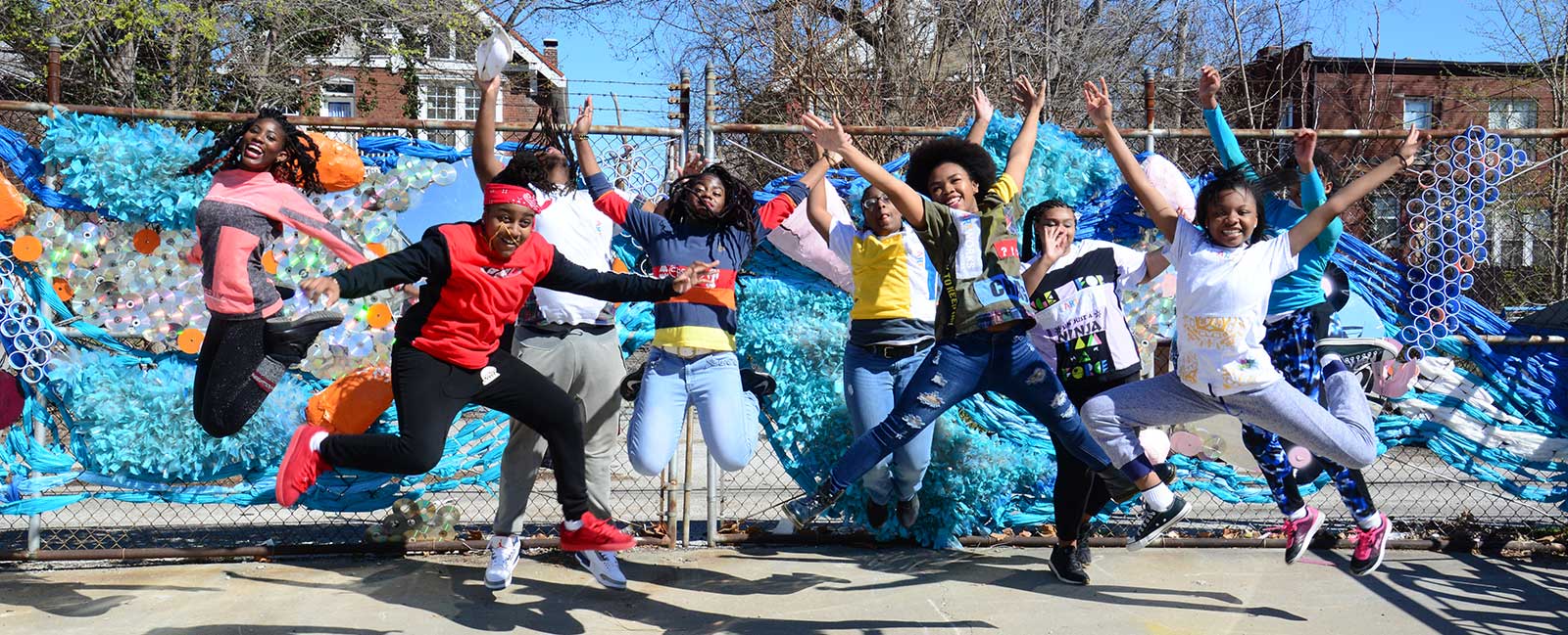 group of students jump up into air