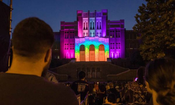 building facade illuminated in a rainbow of colors