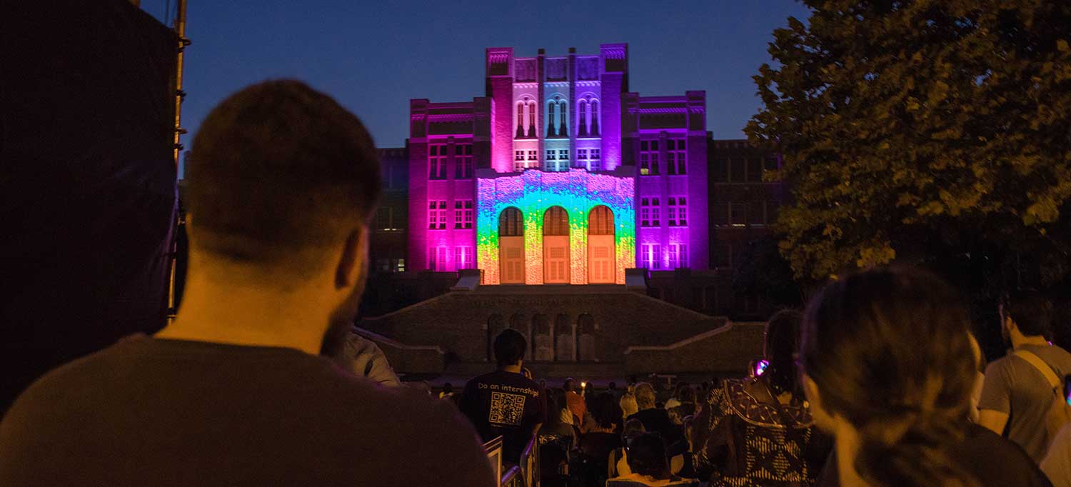 building facade illuminated in a rainbow of colors