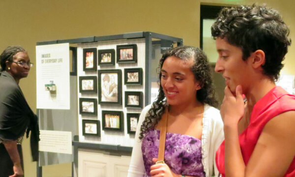 Two women view an NEH on the Road exhibition