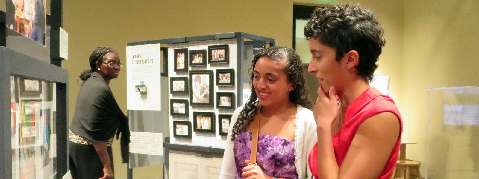 Two women view an NEH on the Road exhibition