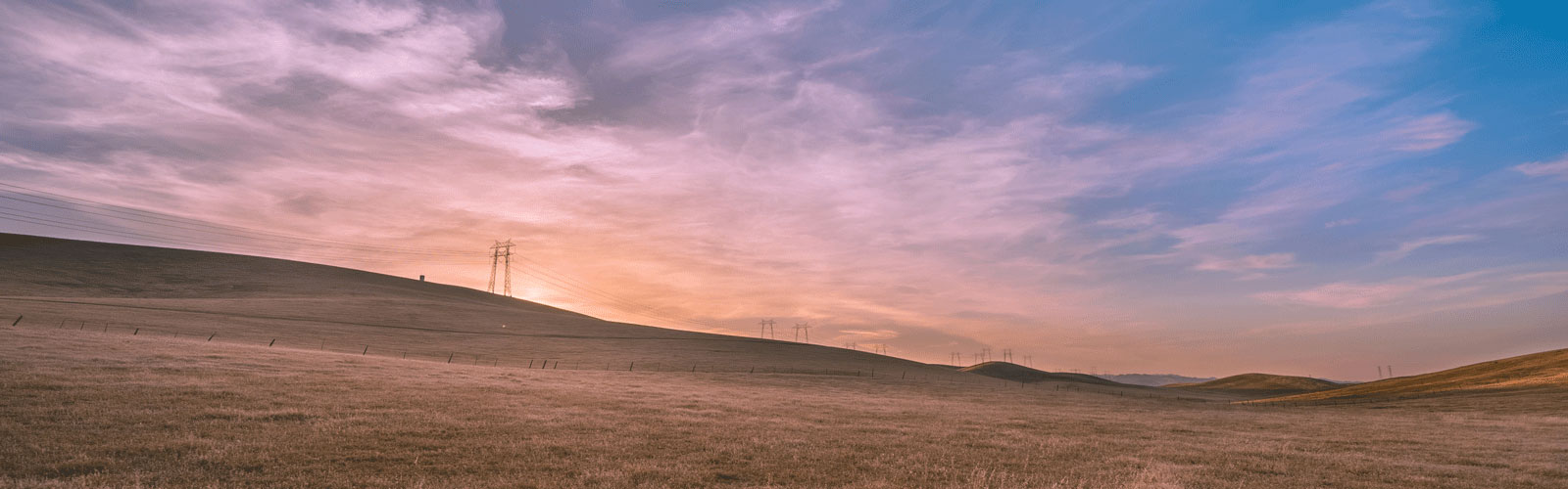 Horizon image with pink sunrise and blue sky.