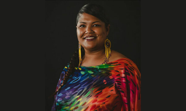 Creative Impact Awardee Lakisha Jackson featured with her headshot where she is smiling and wearing large bright earrings and a colorful blouse.